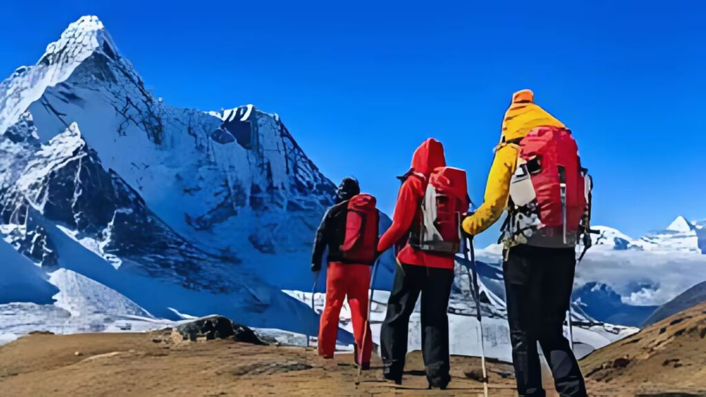 Pilgrims walking on the Kedarnath trekking path surrounded by mountains