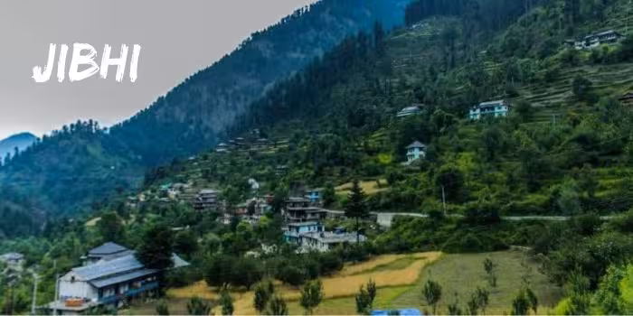 Secluded winter landscape of Jibhi, with snowy hills in the background.