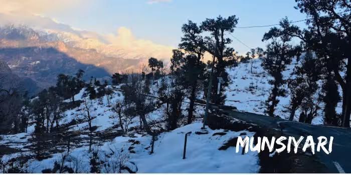 Snow-clad Munsiyari hill station with panoramic views of Himalayan peaks.